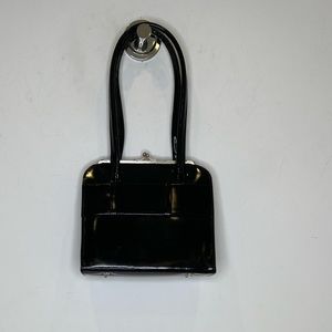 Anya Hindmarch black patent leather top handle, hard frame handbag.